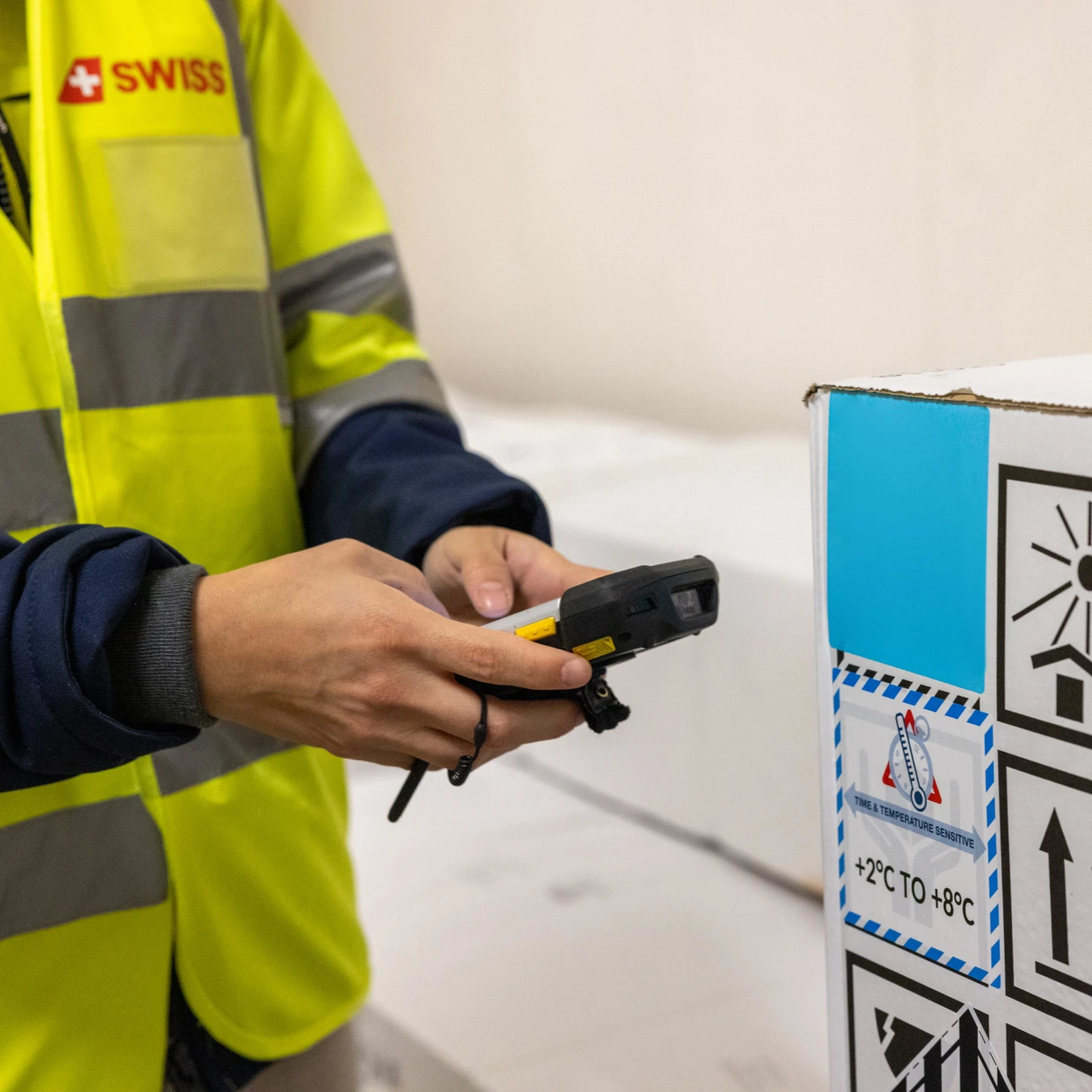 SWISS WorldCargo ground staff managing passive temperature-sensitive cargo at Zurich Hub