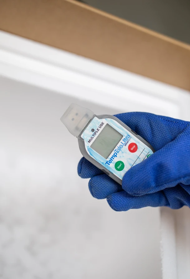 Hand holding a thermometer