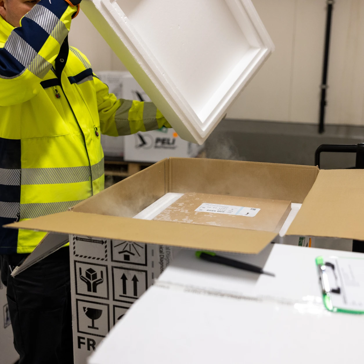 Man is loading a box with dry ice
